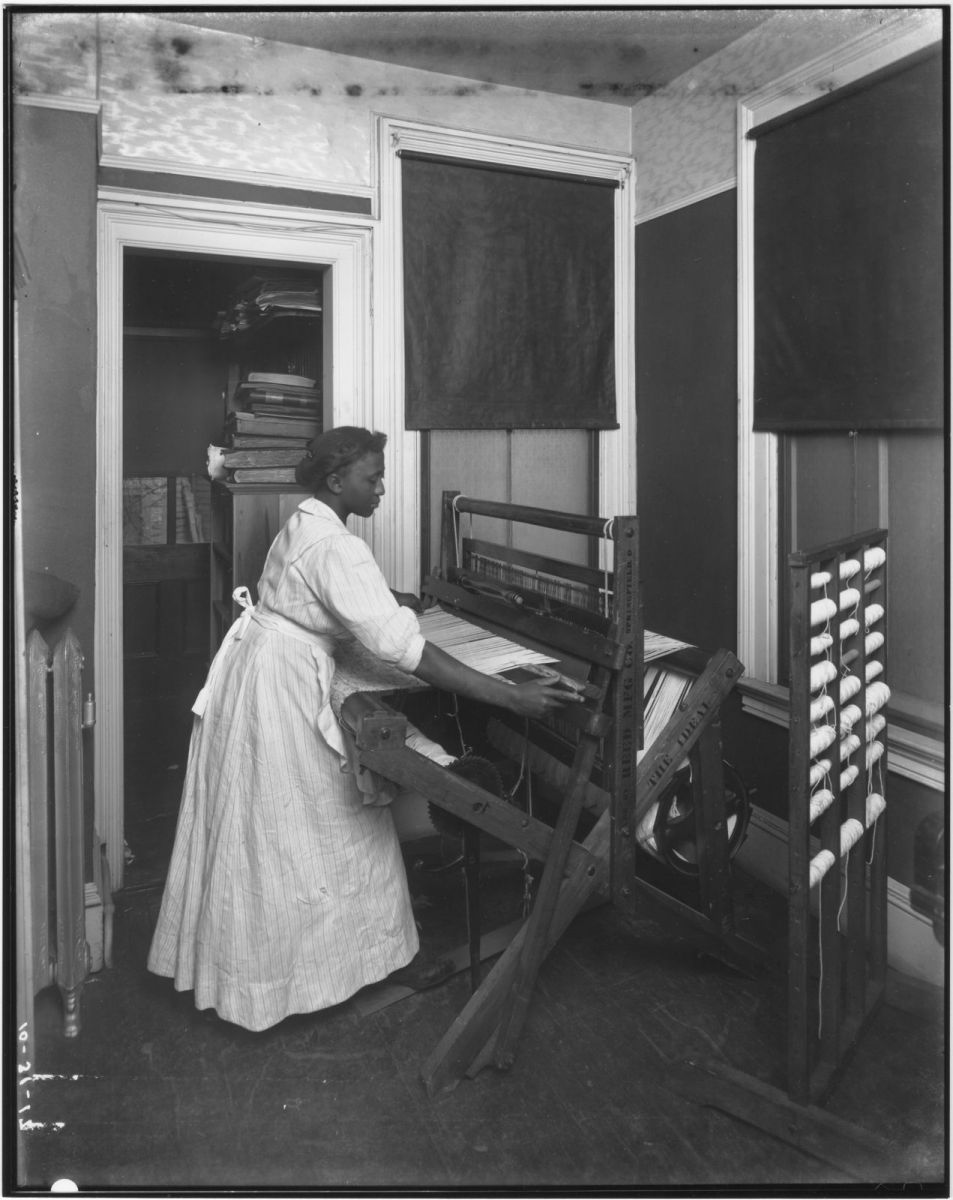 African-American woman working at a loom, Newark, 1917. African-American women worked in the garment trade, which employed mainly Jewish and Italian immigrants in the early 20th century. But because of discrimination most did "piece-work" at home (paid for each piece of clothing they completed) instead of in local factories or shops. In this case, it is unclear whether this woman is working on a home loom or if she is demonstrating the machine in a workshop

Photo and description from the William Cone Collection
